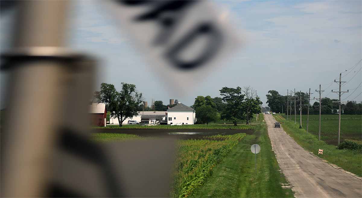 Illinois farm country: a farmstead, fields and crossing a county road