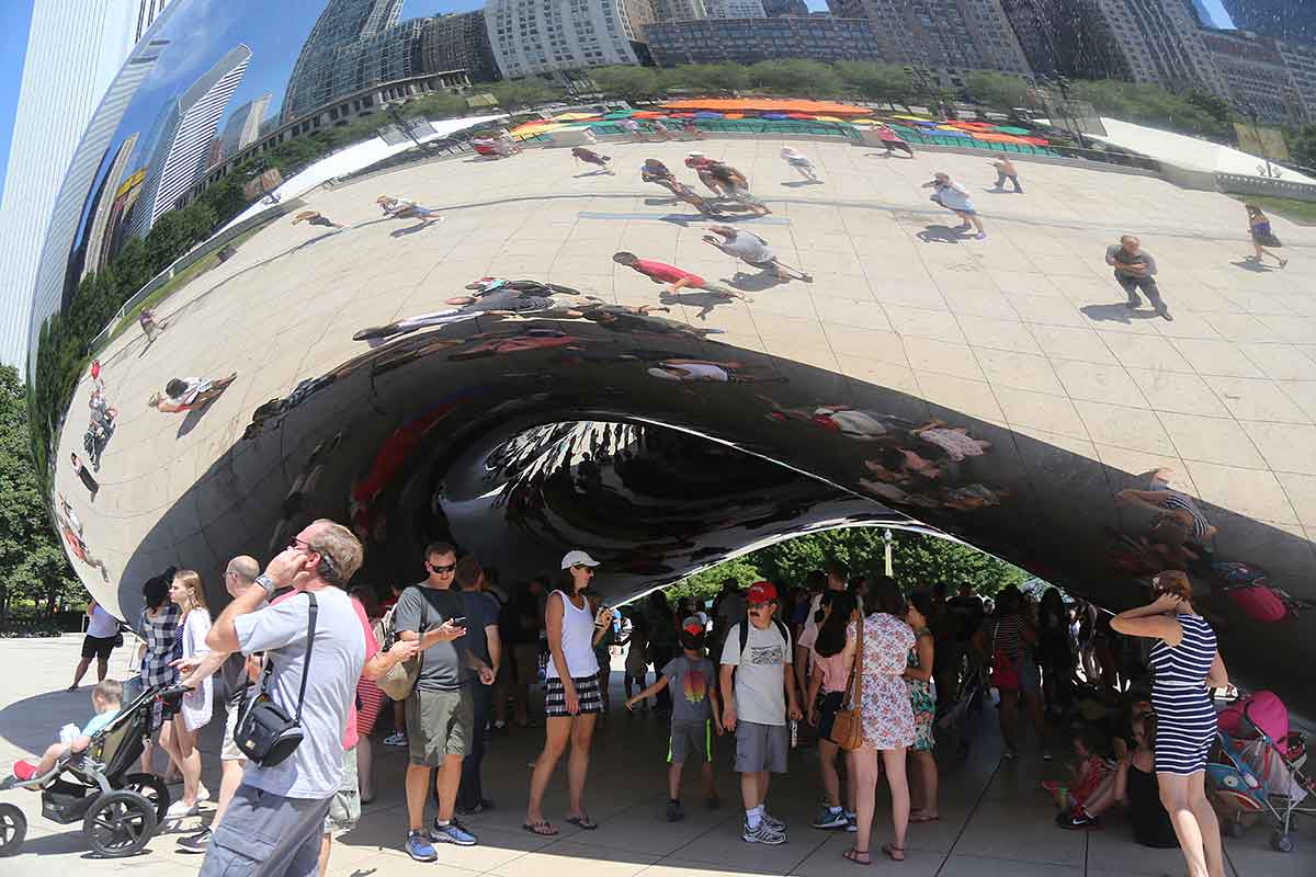 Cloud Gate (the Bean) in Millennium Park, surrounded by people exploring their reflections