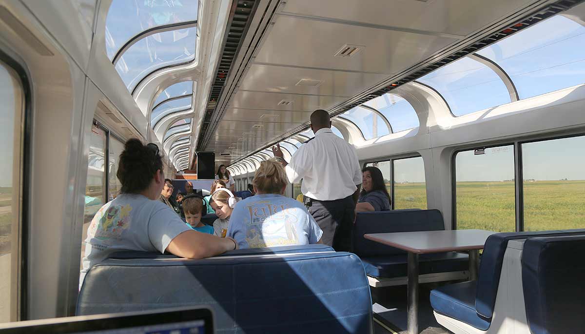 In the sightseer lounge car, with cornfields rolling by outside