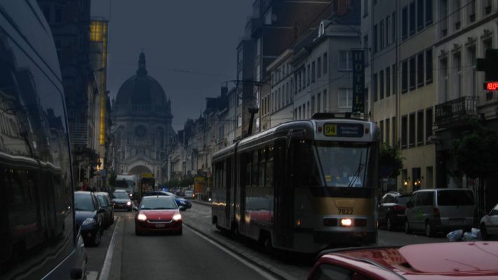 Brussels street at dusk with cars and tram
