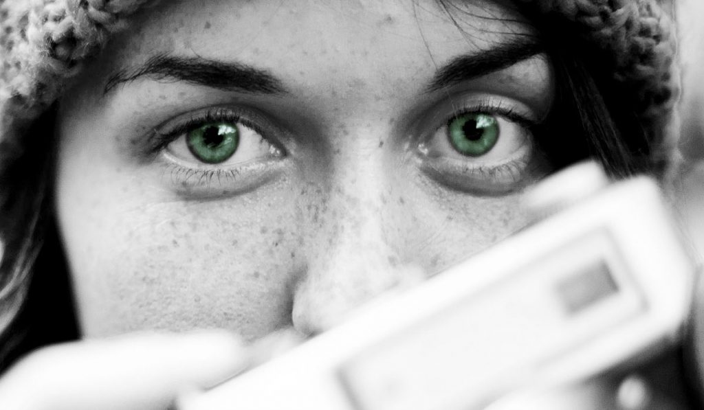 woman looking intently forward over a camera