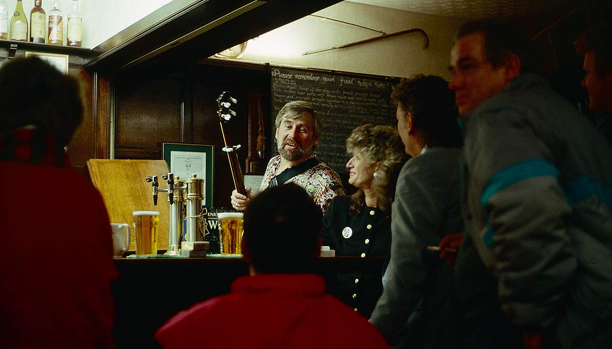 Patrons around the bar in Scottish pub