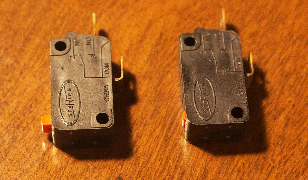 The devil in the detail: Good switch on left, broken switch on right. The small orange tab is the moving part that broke on the right switch.