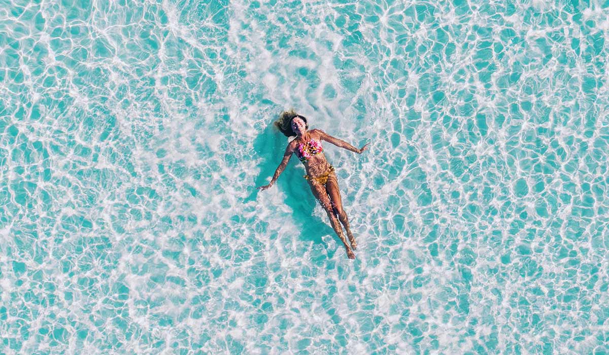 Birds eye view of woman floating in water