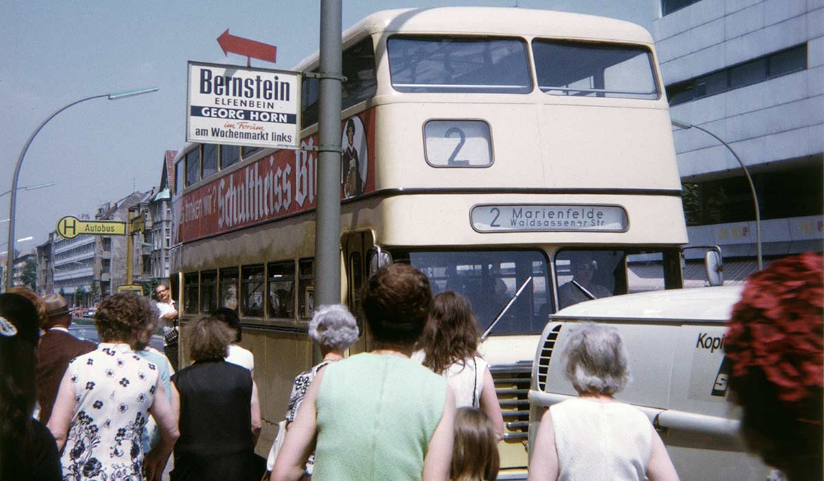 Berlin: bus 2 arriving at bus stop with people waiting