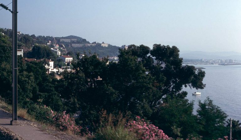 The Riviera coastline from train: cliffs, houses, bay, water