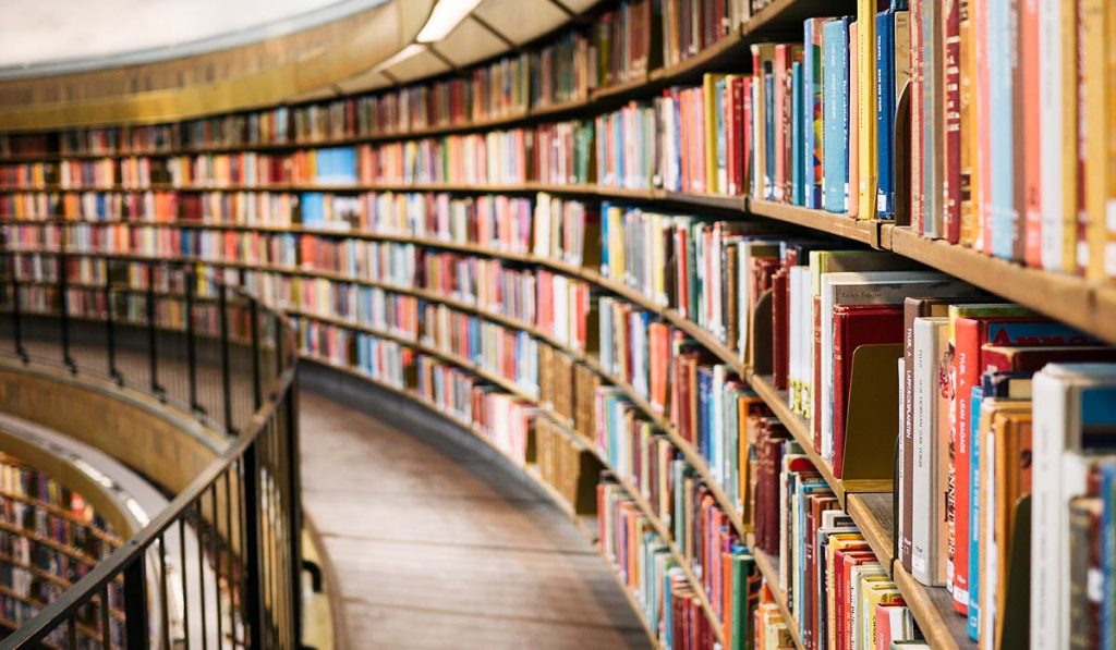 Curved library shelves full of books