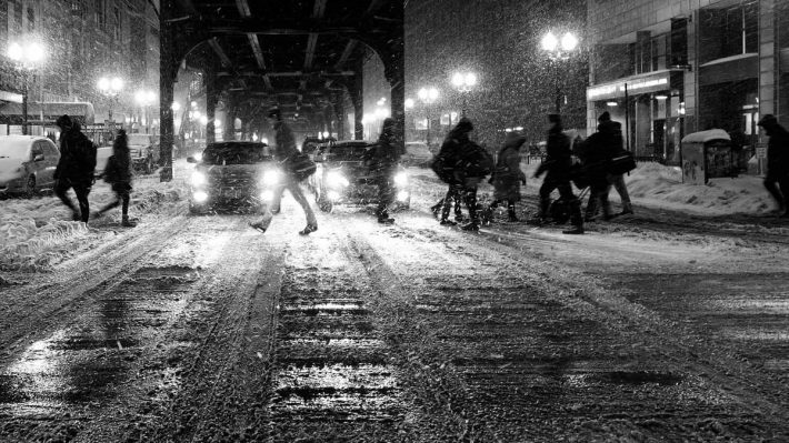 Winter city street, people crossing in snow and slush