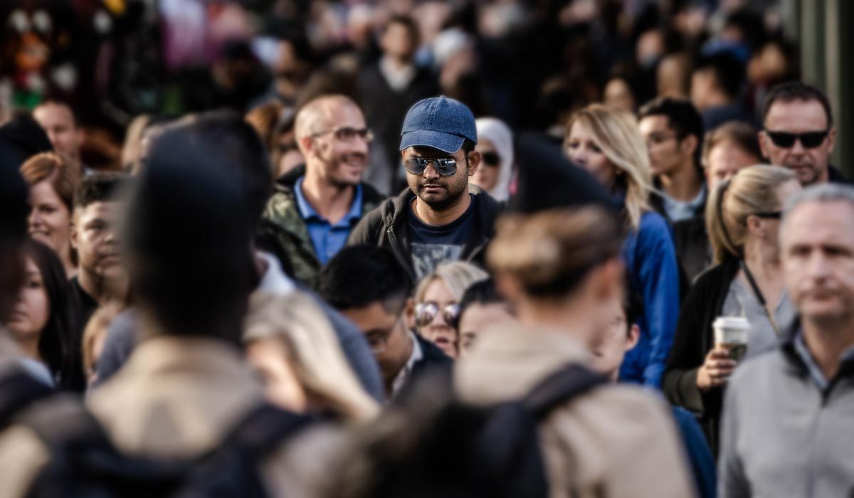One man in focus in a large crowd