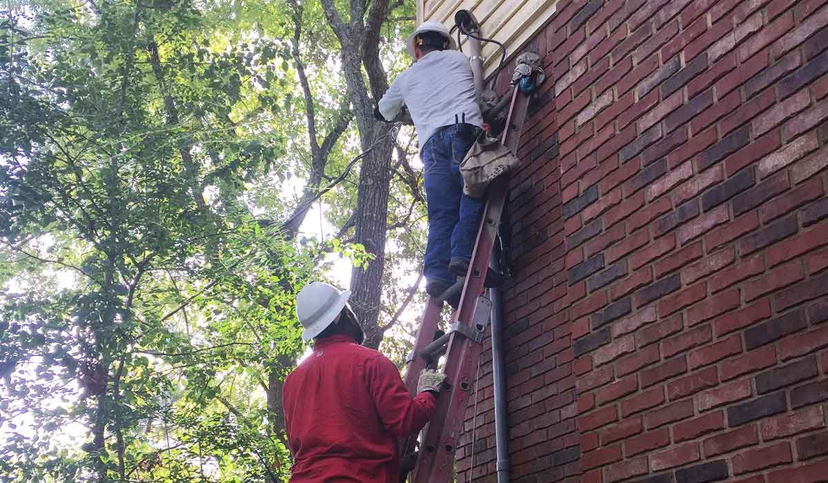 Utility workers reconnect power after the line is put back up