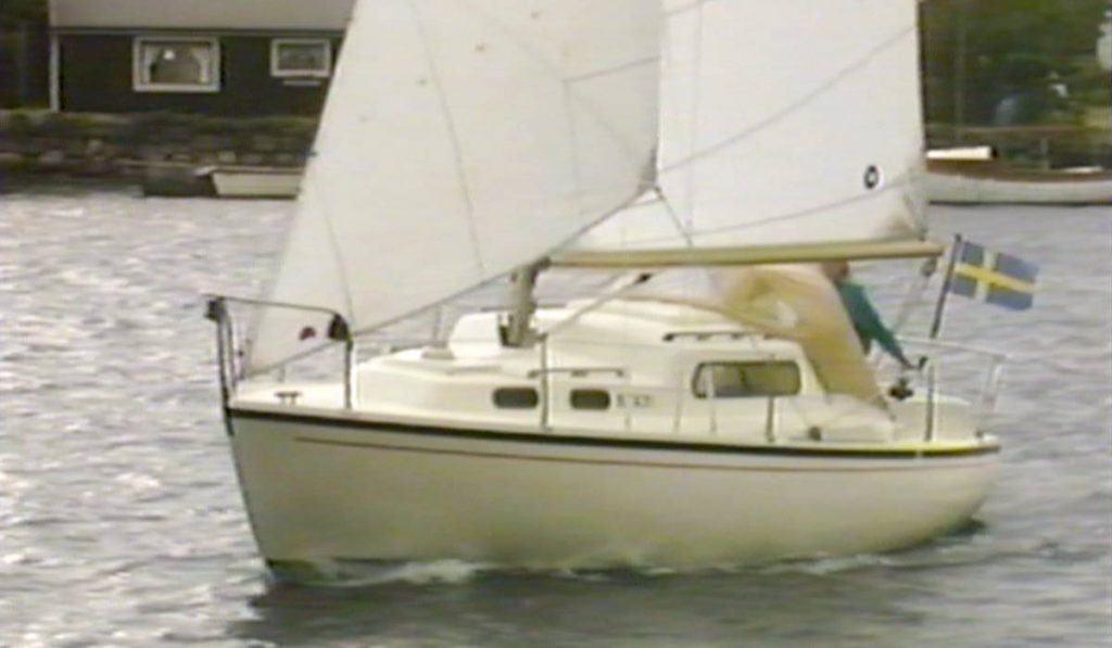 sailboat going into the wind, island in background