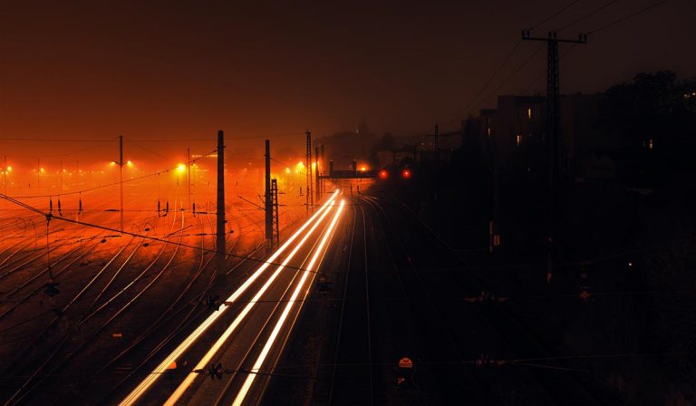 headlights of train, train tracks at night