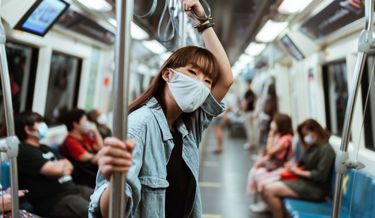 woman wearing mask on subway train
