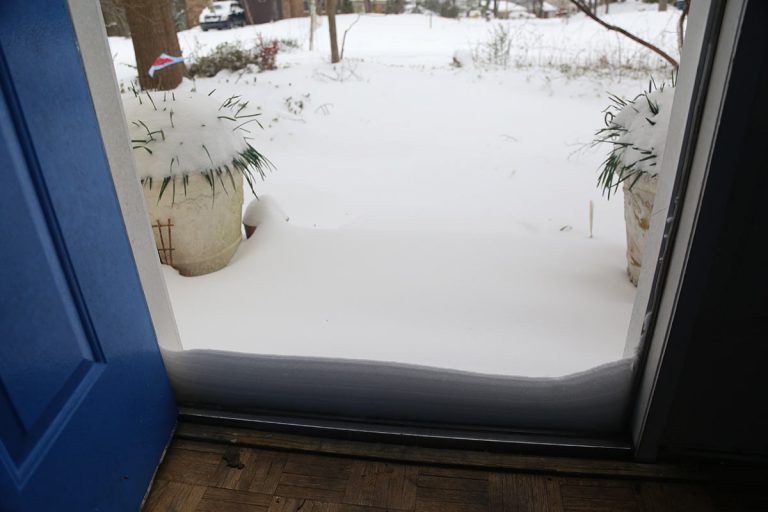 open door with snow piled up against the opening