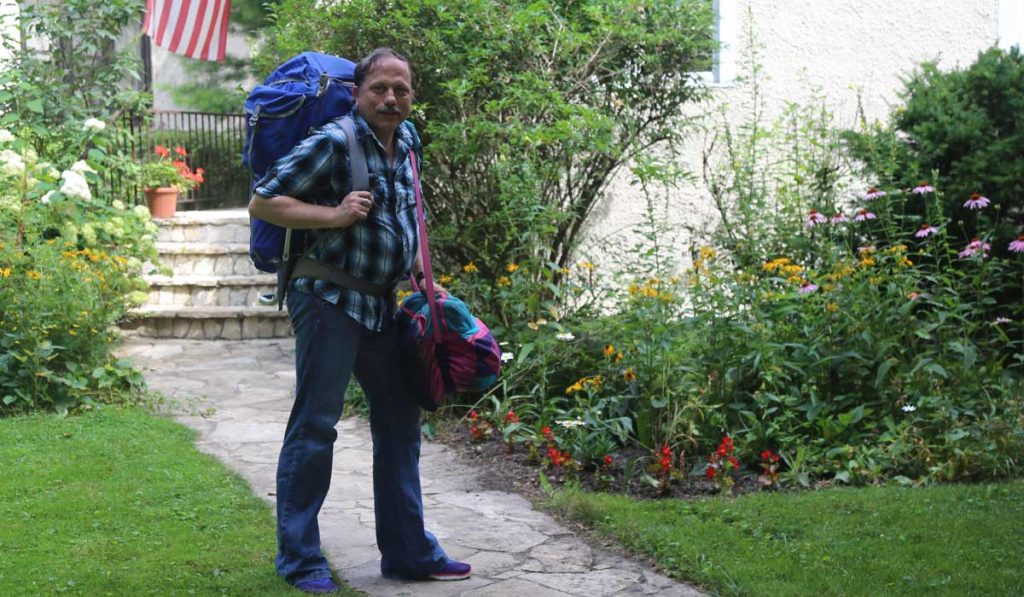 Claes with backpack in front yard