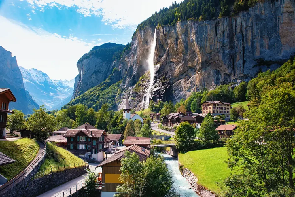 The town of Lauterbrunnen with waterfall and high cliffs