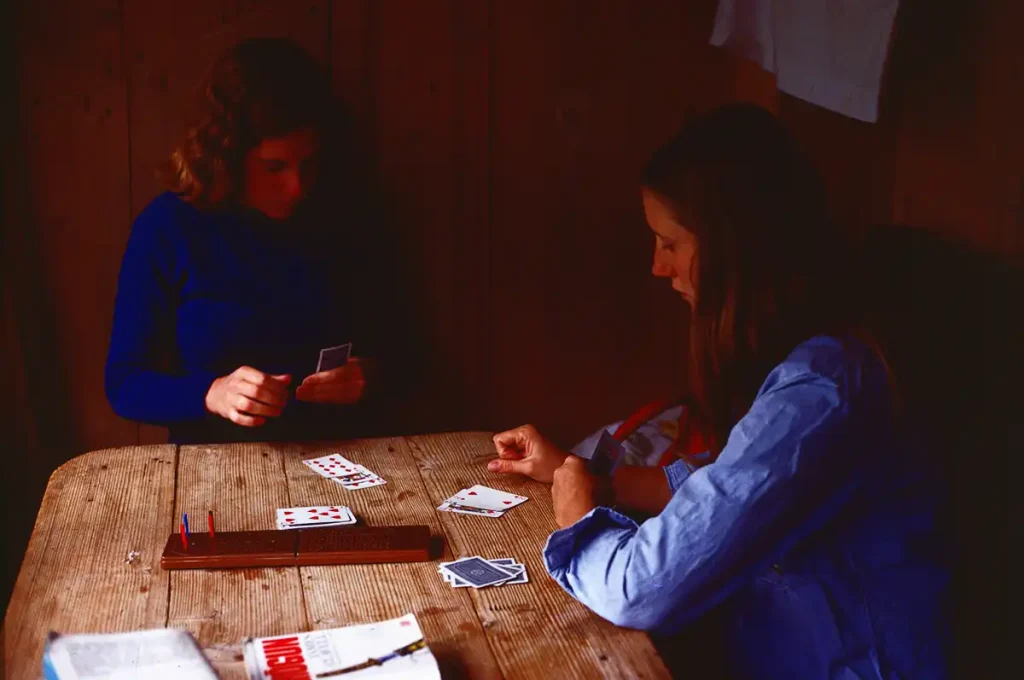 a card game at the hostel as the daylight wanes