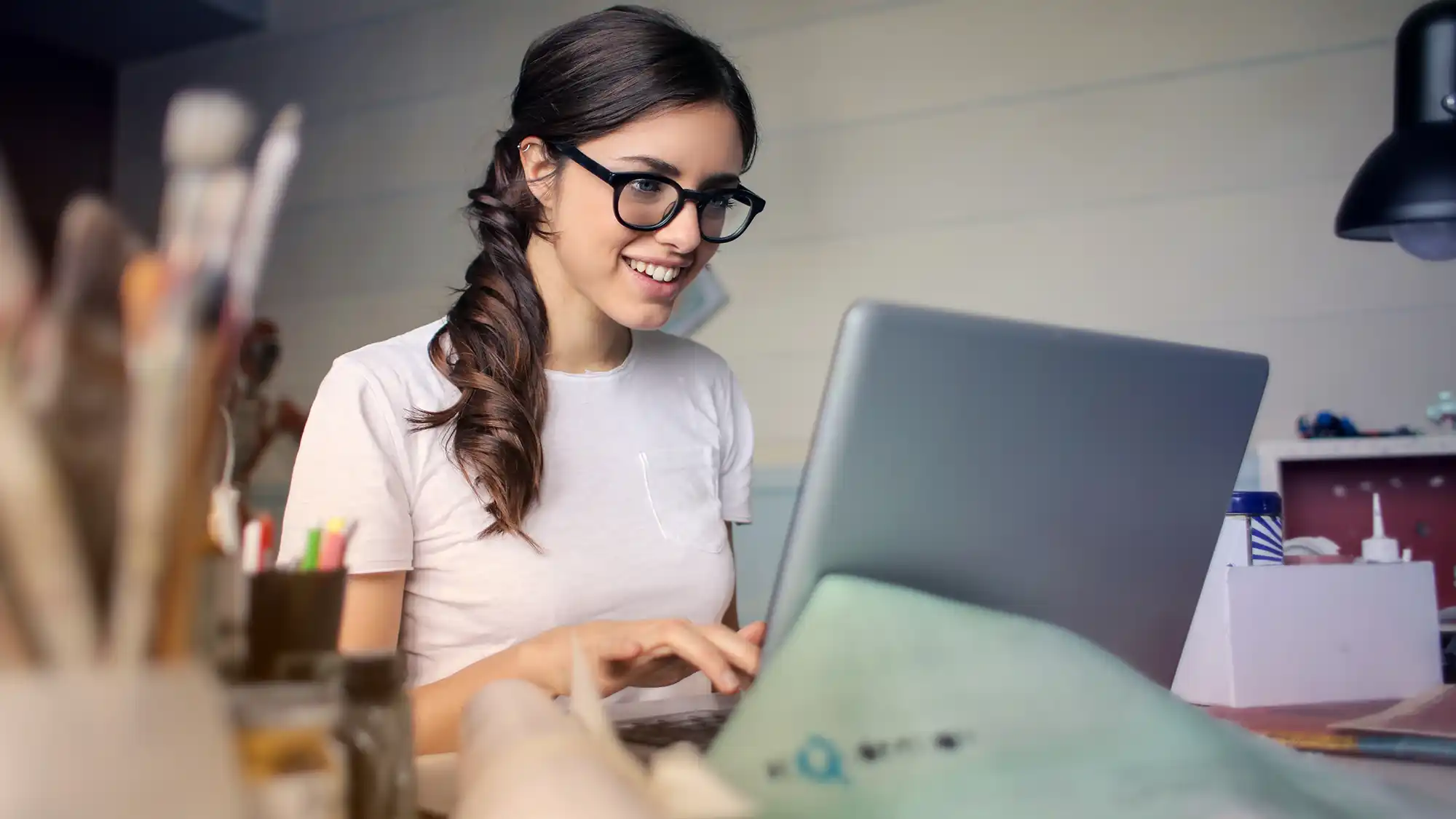 happy woman looking at her computer screen